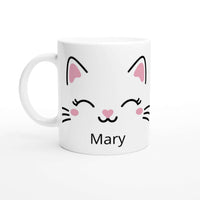 a white coffee mug with a cat face on it