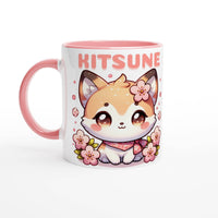 a pink and white coffee mug with a picture of a cat on it