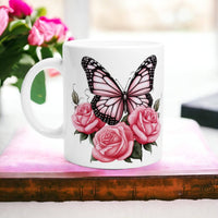 a coffee mug with a butterfly and pink roses on it