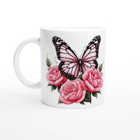 a white coffee mug with pink roses and a butterfly on it