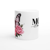 a white coffee mug with a pink rose and a butterfly on it