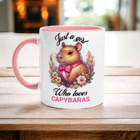 a pink and white coffee mug with a picture of a hamster on it