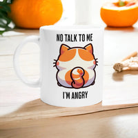 a white coffee mug with an orange and white cat on it