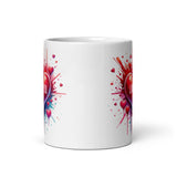 a white coffee mug with hearts and splatters on it